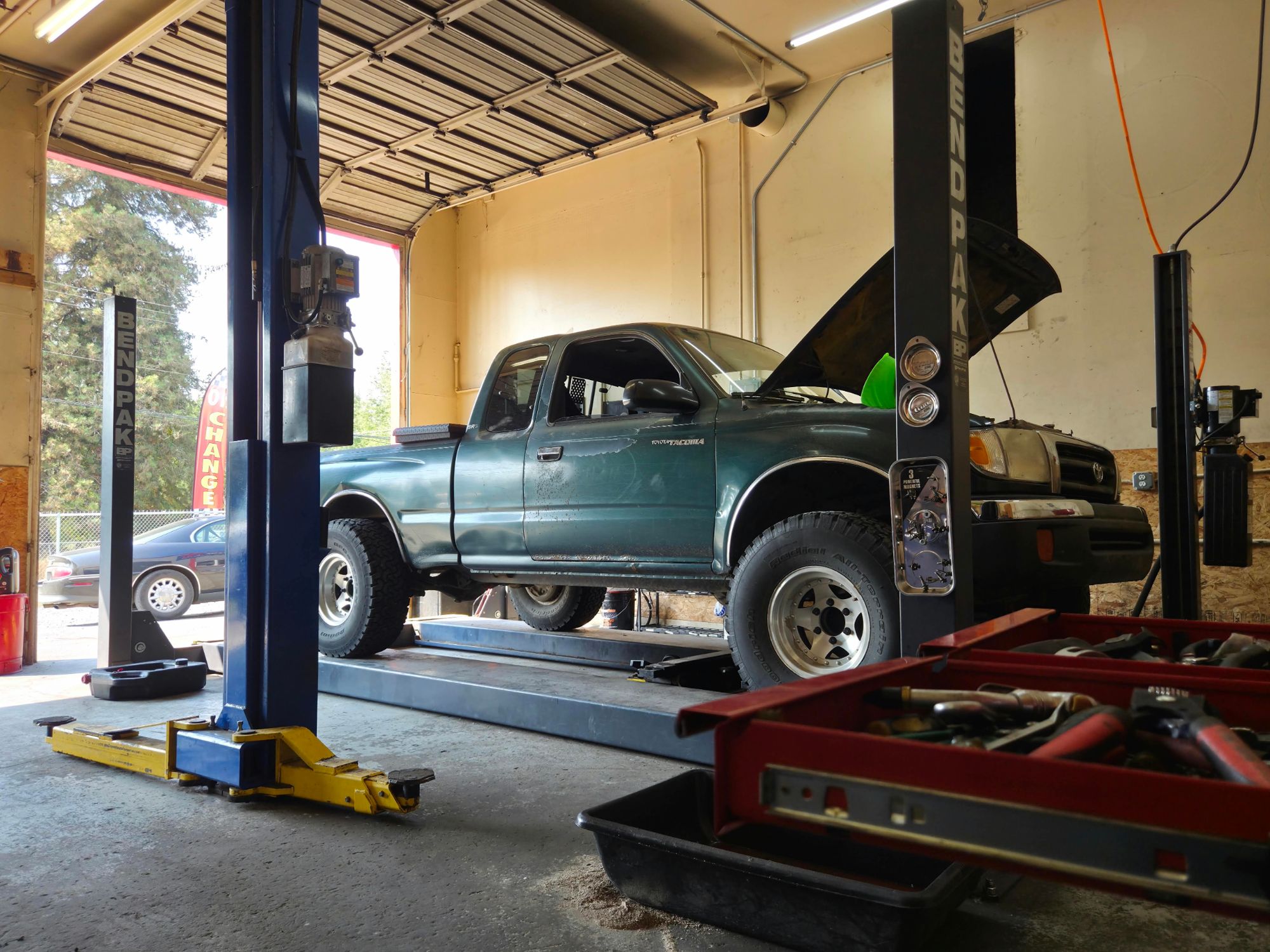 Toyota Tacoma 4x4 raised on the shop lift