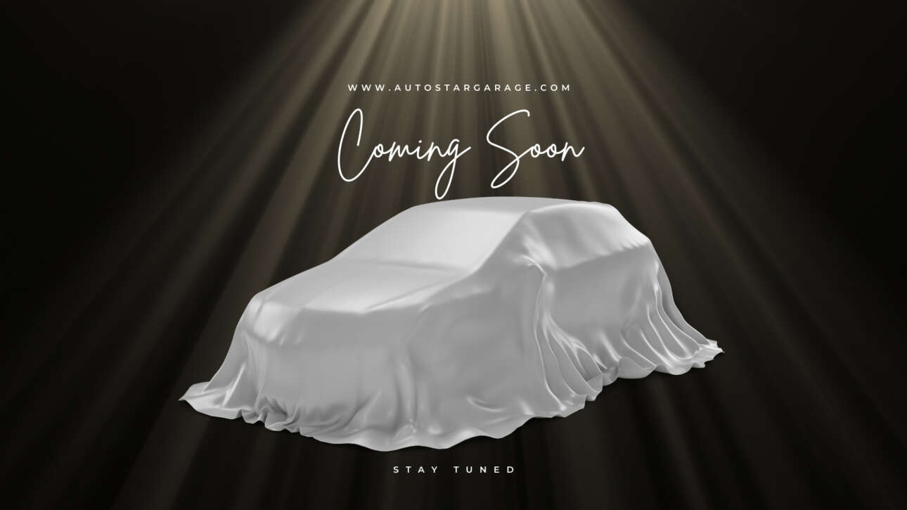 White car covered with a cloth, illuminated by beams of light, featuring "Coming Soon" text, related to upcoming Porsche 911 GT3 availability at Auto Star dealership.