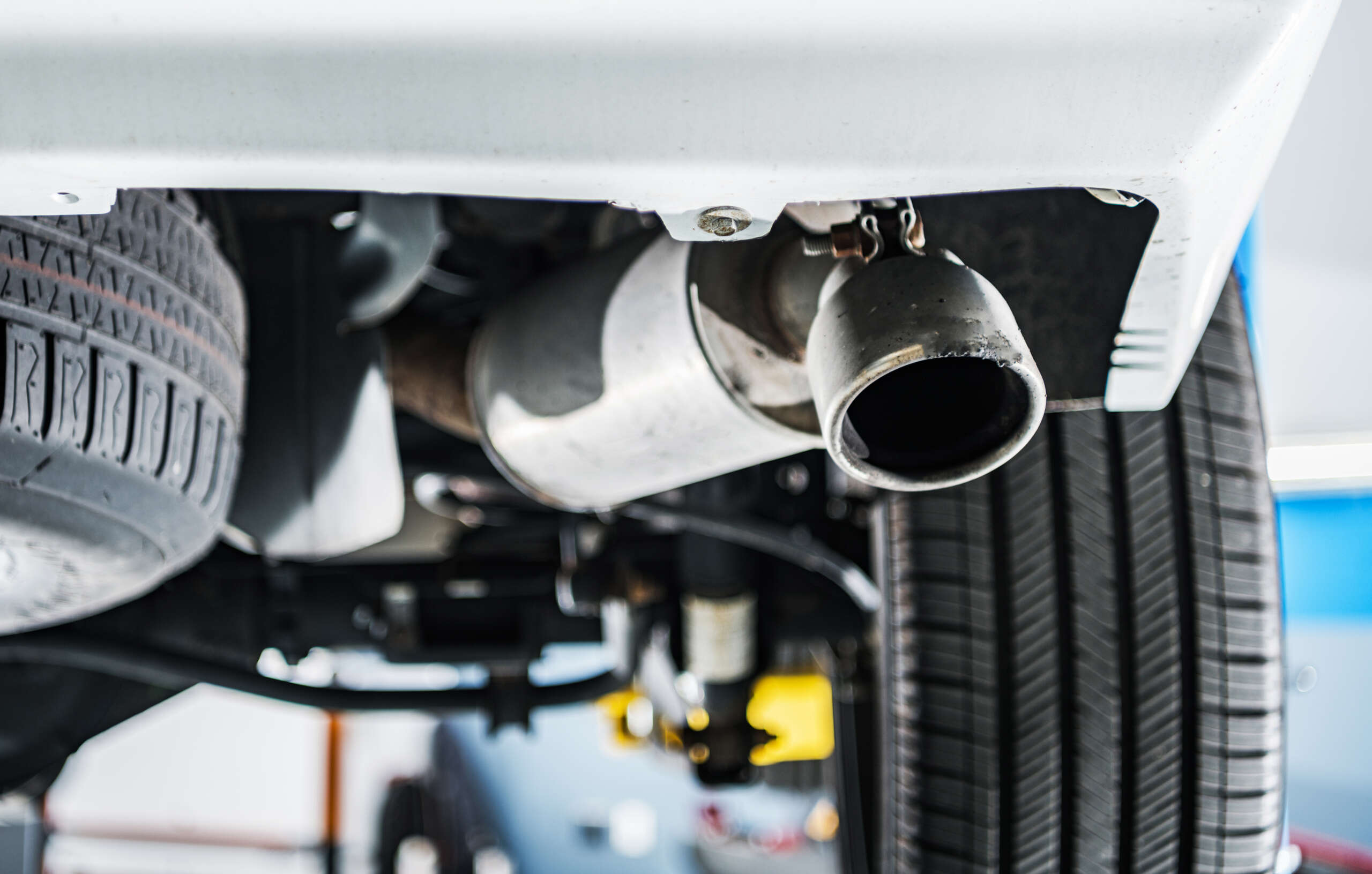 Exhaust system view highlighting muffler and tire, emphasizing vehicle emissions repair services at Auto Star.